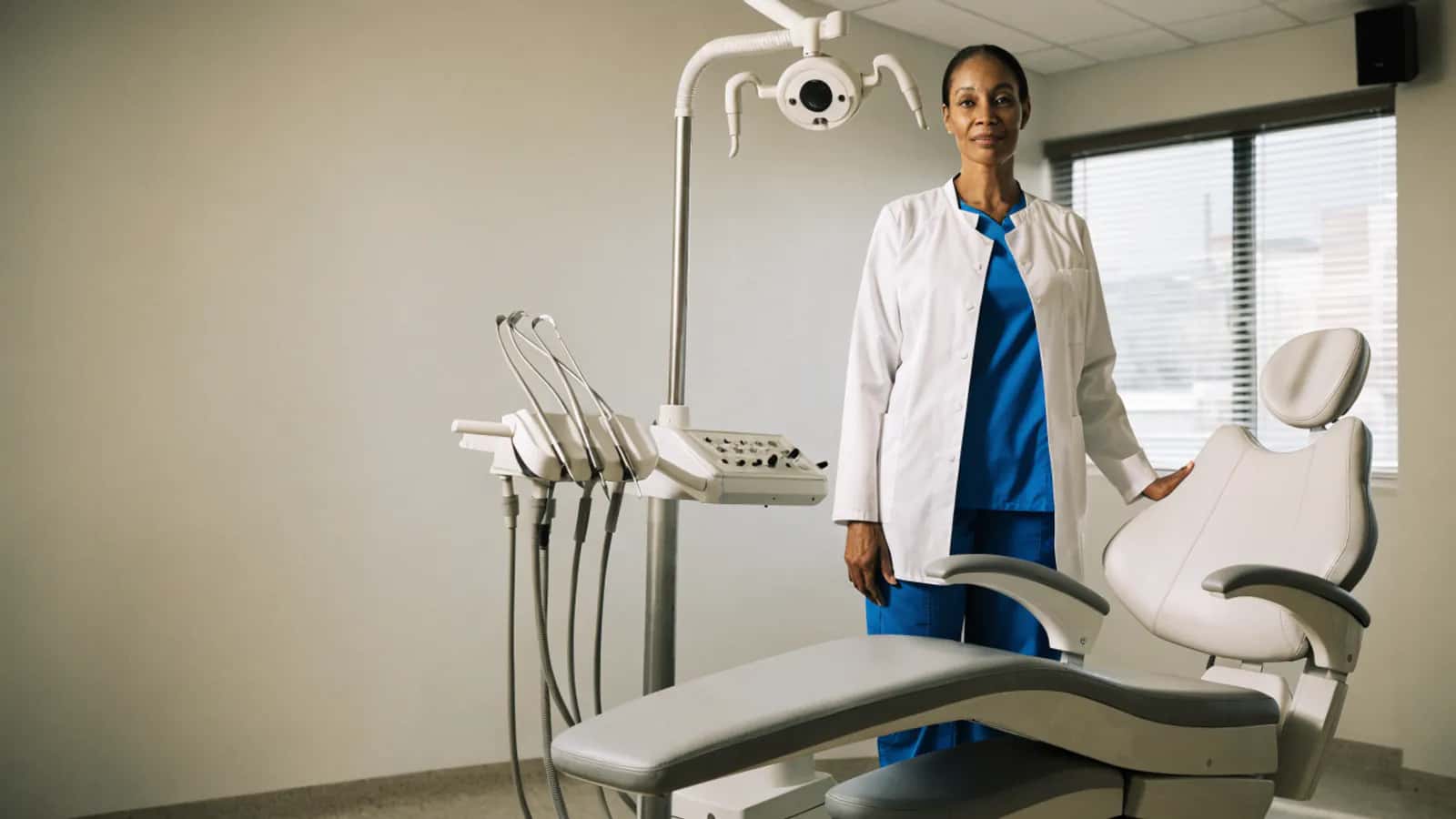 Experienced dentist standing in a contemporary dental operatory