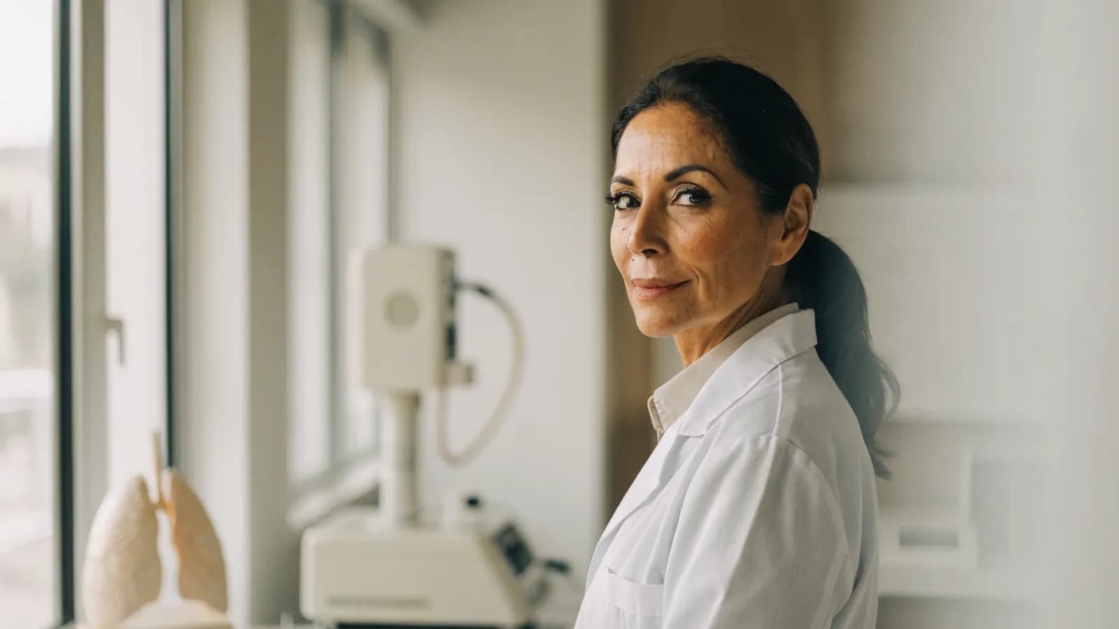 Allergist in a bright clinic with respiratory assessment equipment